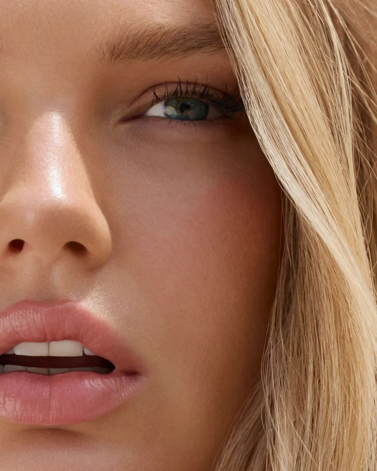 Close-up of a woman's face with blonde hair and blue eyes.