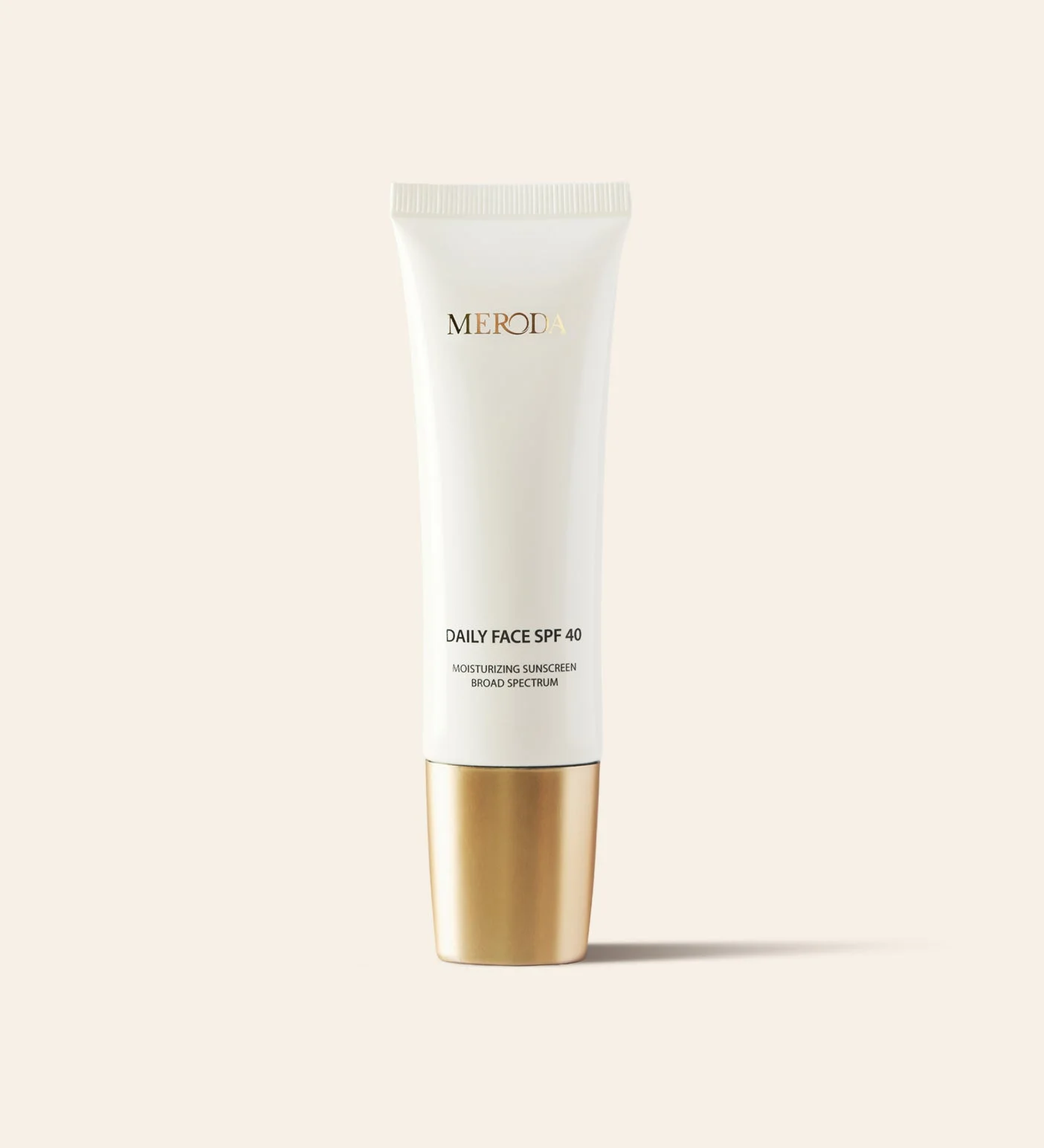 Daily Face SPF 40 broad-spectrum moisturizing sunscreen in a sleek white tube with a metallic gold cap.