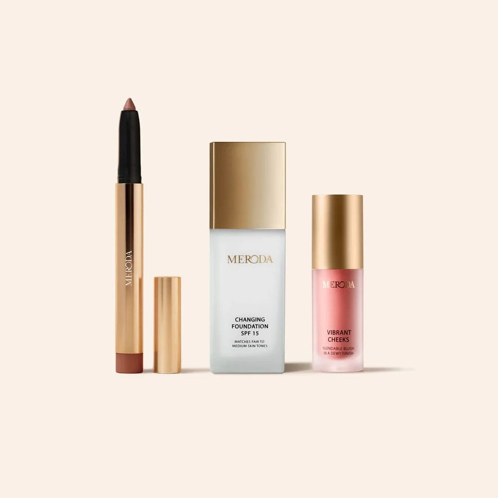 The No-Makeup Makeup Kit featuring Changing Foundation, gold Eye Perfecting Shimmer Stick, and Vibrant Cheeks Liquid Blush.