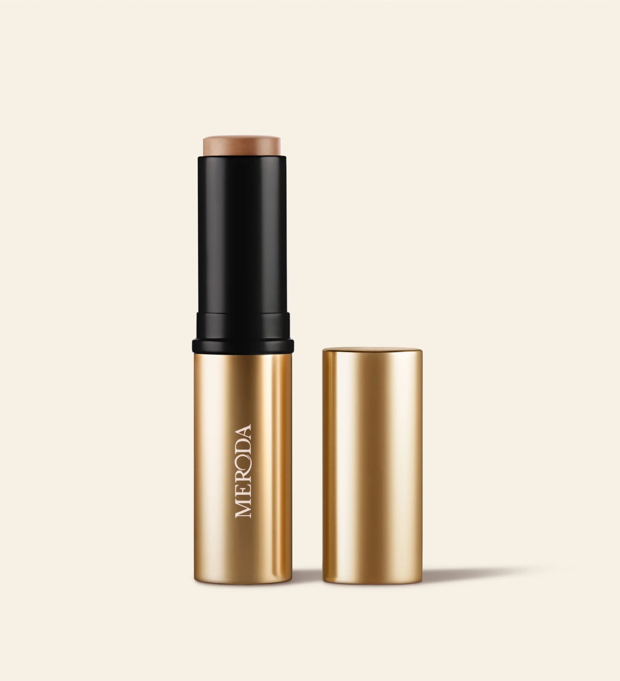 Meroda Cosmetics Soft Tan Bronzer in Light featuring gold packaging and cap removed to show the creamy stick formula