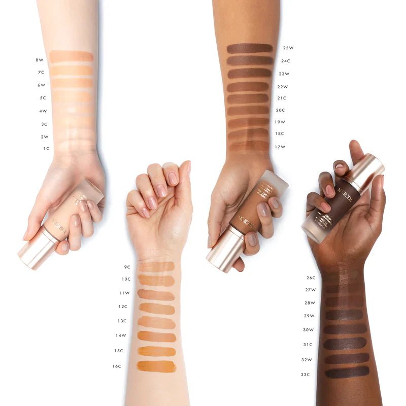 Universal Foundation shade swatches on four arms with diverse skin tones holding Meroda Cosmetics bottles.
