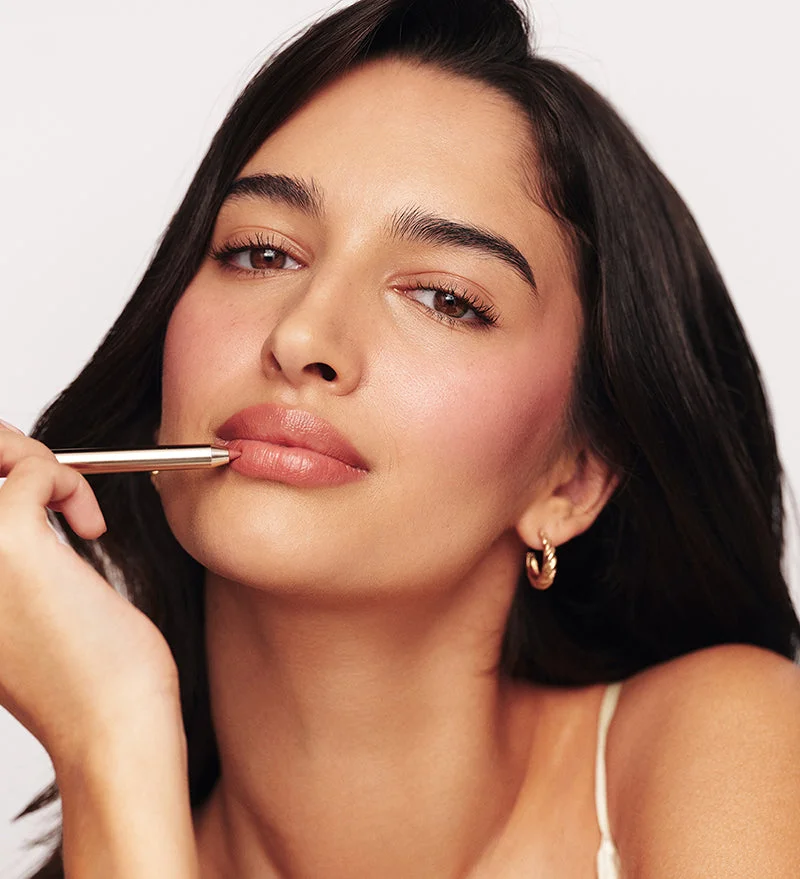 Model applying the Signature Lip Pencil for defined, nude lips, featuring the Perfect Nude Lip Duo.