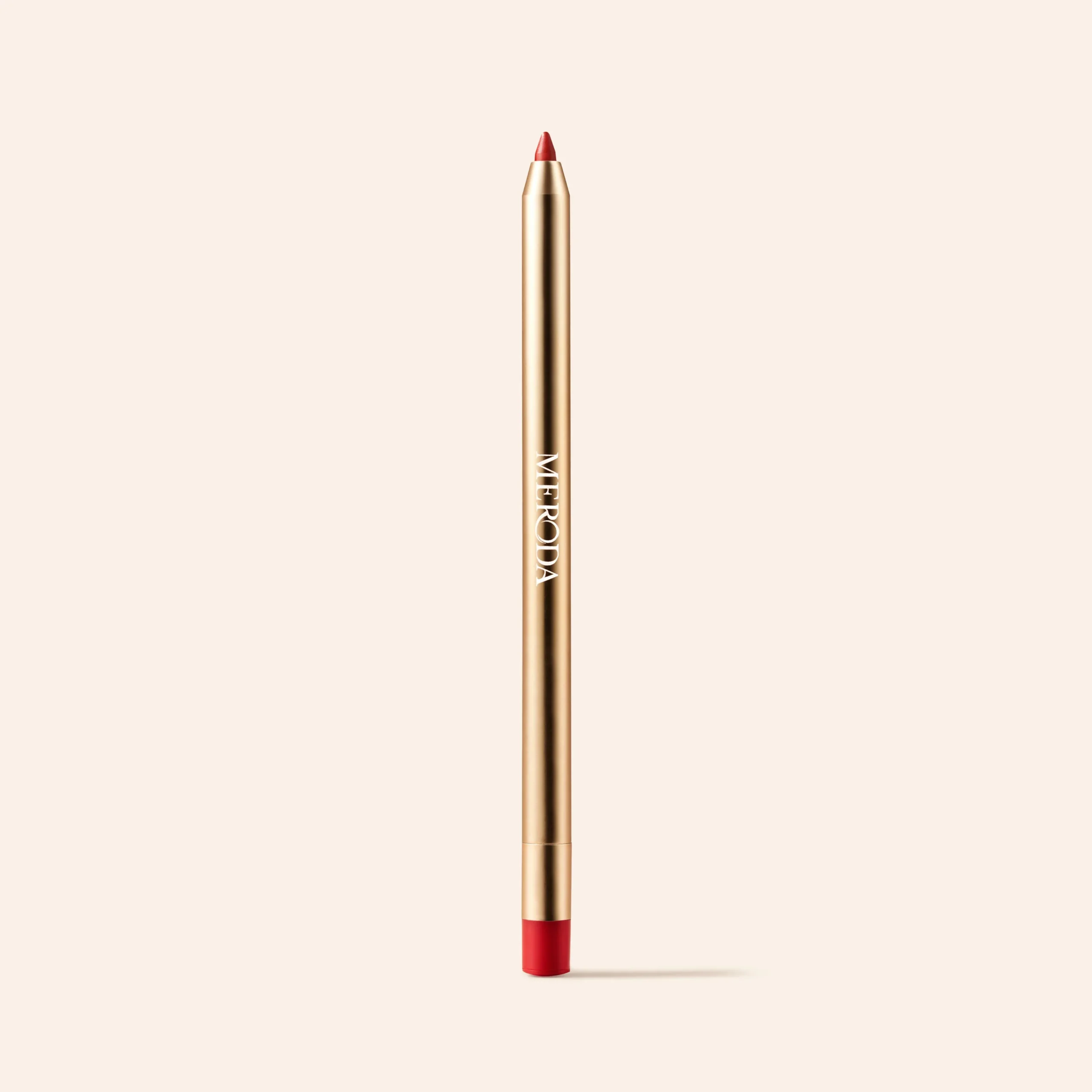 Signature Lip Pencil in Luscious Red is a metallic gold liner with a red tip and base on a cream background.