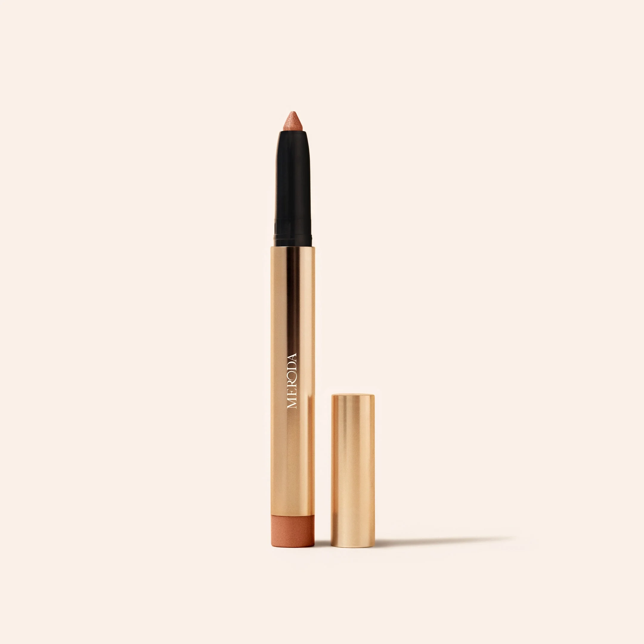 Meroda Cosmetics Eye Perfecting Shimmer Stick in Gold shown open with cap against a light background