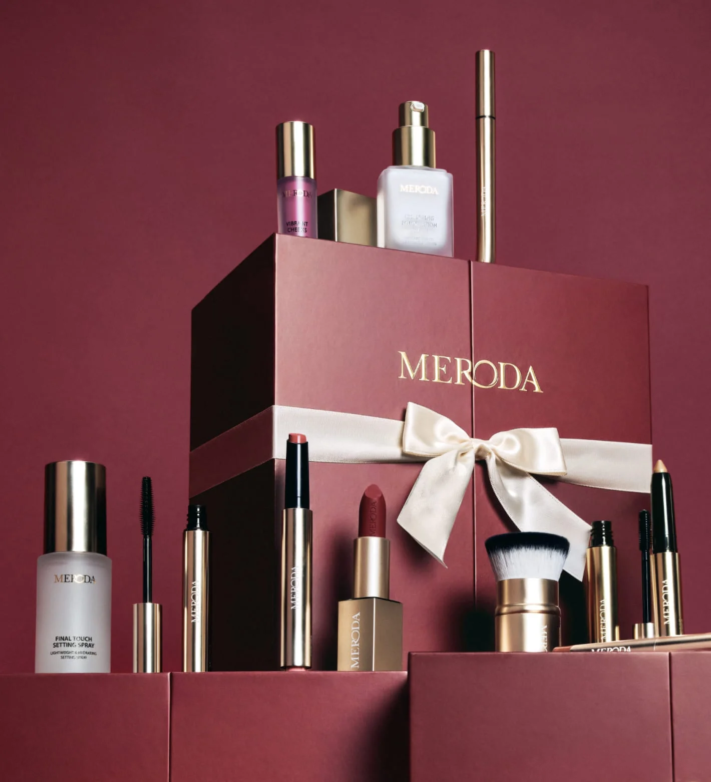 Advent Calendar - 12 Days of Effortless Beauty displayed in burgundy packaging with a gold ribbon and makeup products.
